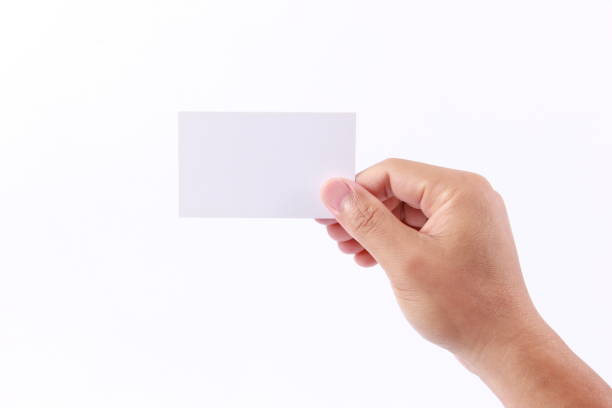 istock Man hand holding a blank business card, isolated on white background 1258863029