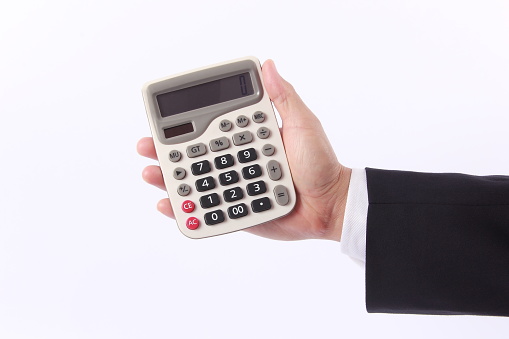 Business man hand holding calculator, isolated on white background
