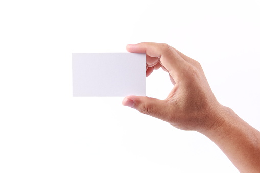 Man hand holding a blank business card, isolated on white background