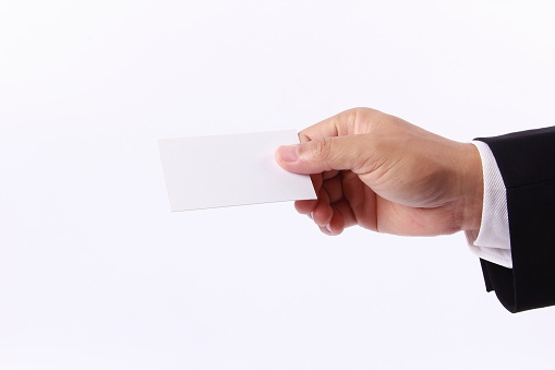 Business man hand holding a blank business card, isolated on white background