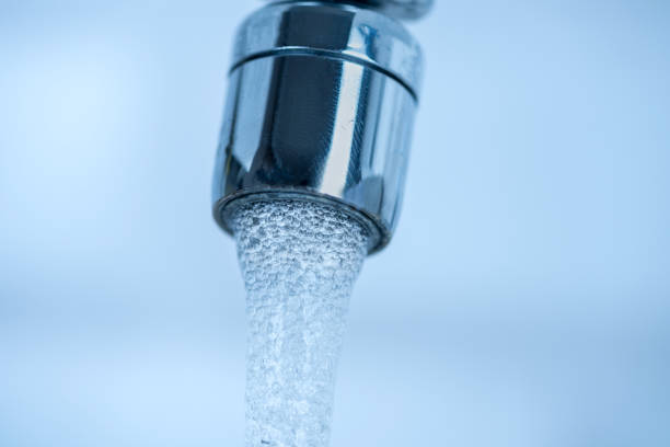 istock Pouring water from a Faucet 1258867803