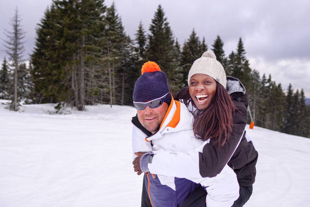 istock Young friends with snowboard on winter holiday 1258868841
