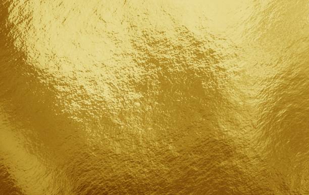 istock Gold foil background with highlights and uneven texture 1258875717