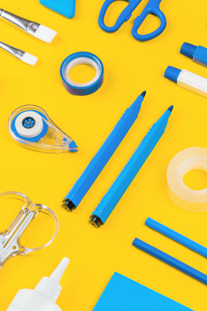 istock Assorted office and school white and blue stationery on yellow 1258888984