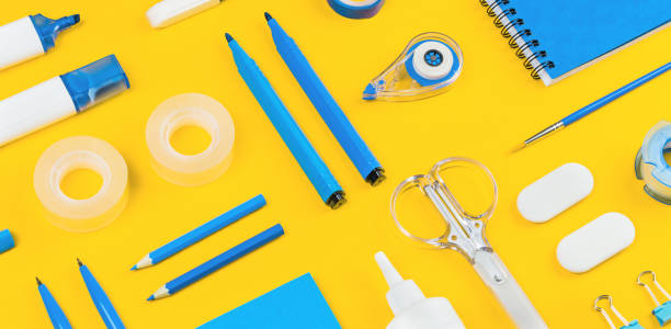 istock Assorted office and school white and blue stationery on yellow 1258888987