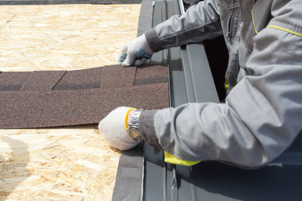 Professional worker lays asphalt tile sheet on the roof