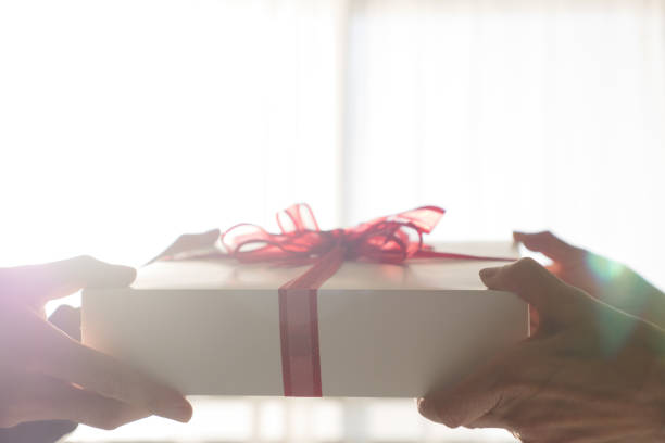istock Give the present box with a ribbon 1258893269