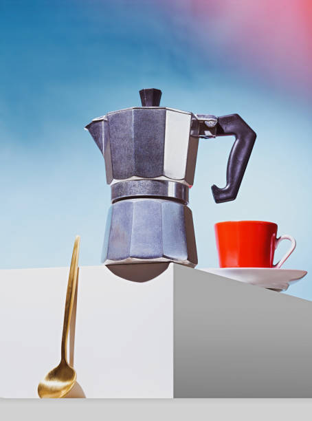 istock Geyser coffee maker, golden spoon and red cup for coffee shop stand on a white cube 1258914404