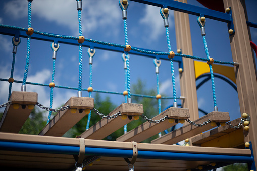 Rope ladder on the playground. Play area for children. Modern rope platform.
