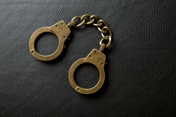 istock image of handcuff leather background 1258948520