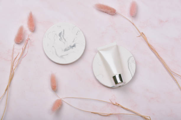 Cosmetic bottle containers on pink marble background, Blank label package for branding mock-up, Natural organic beauty product concept, Research and development of purified skincare.