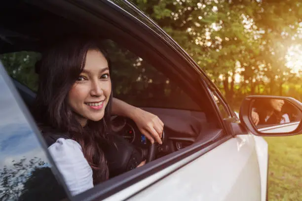 happy young woman in a car