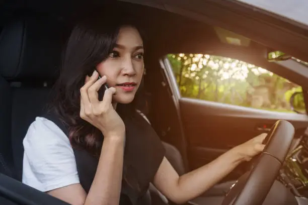 woman driving a car and talking on mobile phone
