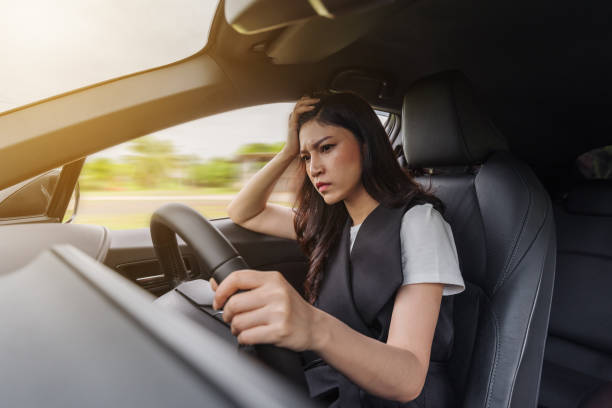 istock stressed woman sitting inside a car 1258985878
