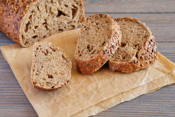 istock Rye and wheat bread with sunflower seeds on a wooden table 1258996151