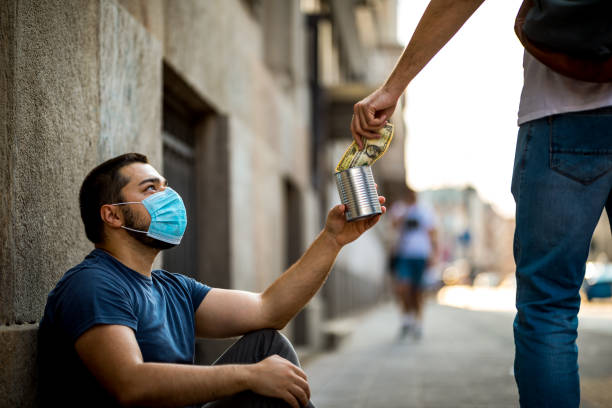 istock Homeless man receiving money 1259000214