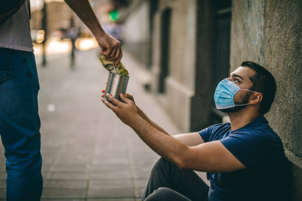 istock Man giving money to beggar 1259000782