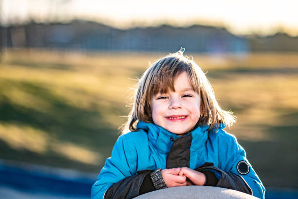 Happy little boy is having fun outside at the playground