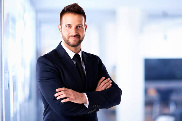 istock Businessman portrait while standing in the office 1259022467