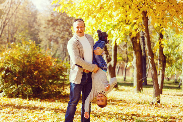 istock dad and son on a autumn park background 1259033173