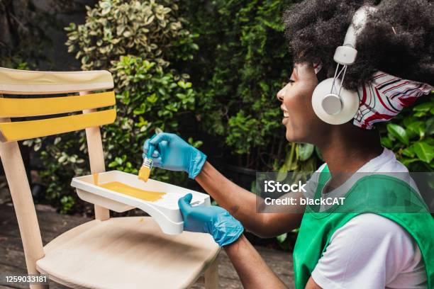 African American Woman Is Painting A Chair At Home Stock Photo - Download Image Now - DIY, Yard - Grounds, Home Improvement
