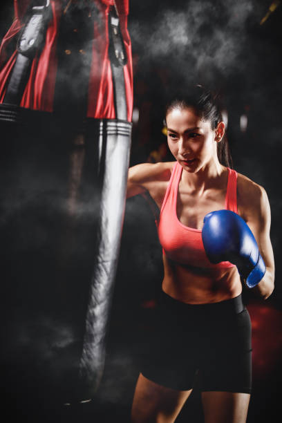 istock asian woman training with punching bag 1259036750