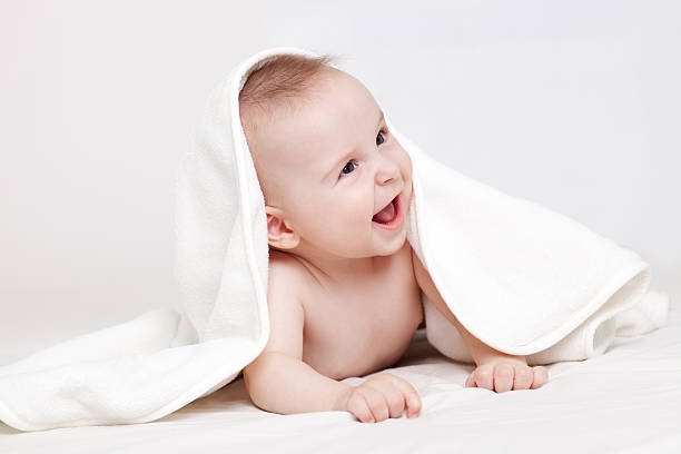 istock Cute baby smiling under white blanket 125903868
