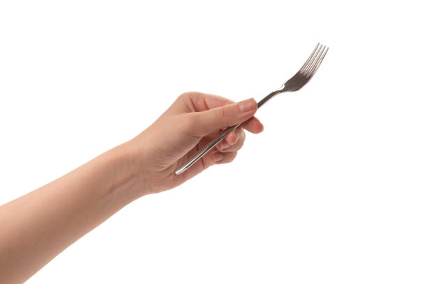 istock Fork in woman hand isolated on white. 1259038837
