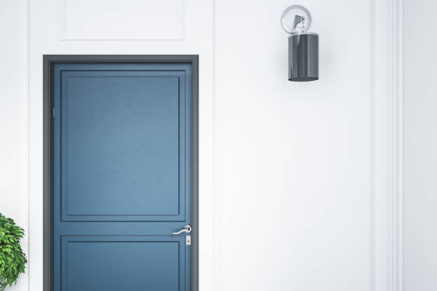 istock Modern home interior with blue door with blank wall. 1259038881