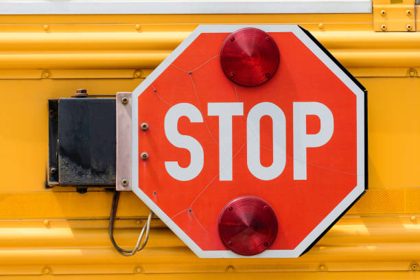 istock Generic plastic traffic light sign showing stop with white and red on a vivid yellow metallic surface 1259039039