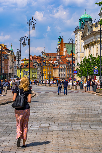 Warsaw, Poland - May 25, 2019: View to Old Town from Krakowskie Przedmiescie street, Royal Avenue, part of the Royal Route in capital city
