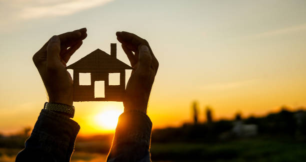 istock real estate agent holding house 1259050676