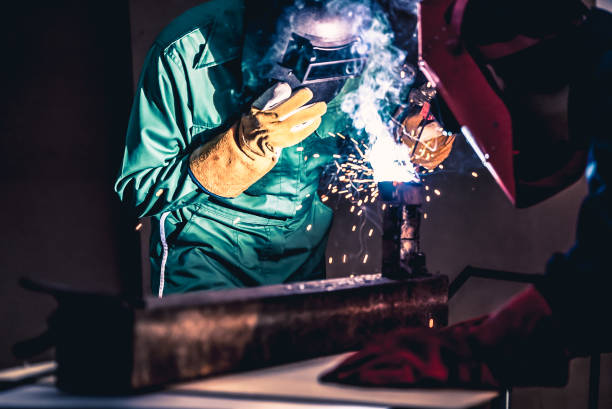 istock Metal welding steel works using electric arc welding machine 1259054410