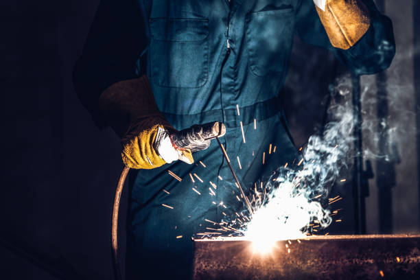 istock Metal welder working with arc welding machine. 1259056609