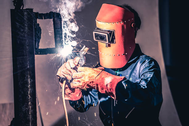 istock Metal welding steel works using electric arc welding machine 1259067061