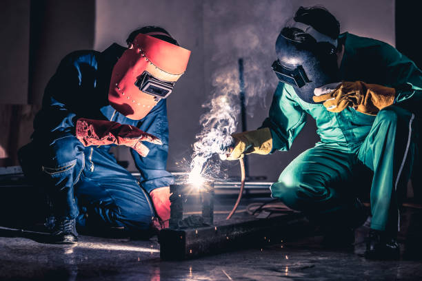 istock Metal welding steel works using electric arc welding machine 1259072008