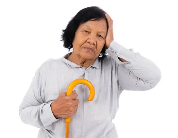 stressed senior woman with a walking cane isolated on a white background