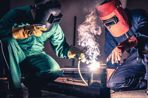 istock Metal welding steel works using electric arc welding machine 1259073630