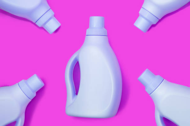 istock Blue bottles on purple background. Cleaning concept 1259096982