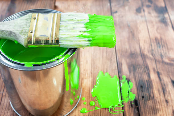 istock Paint brush and can on wooden surface 1259104888