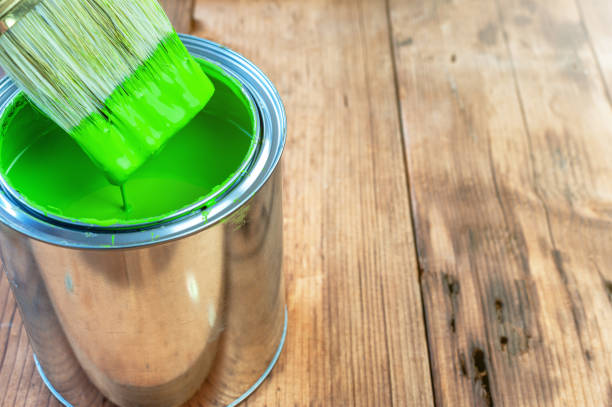 istock Paint brush and can on wooden surface 1259105961