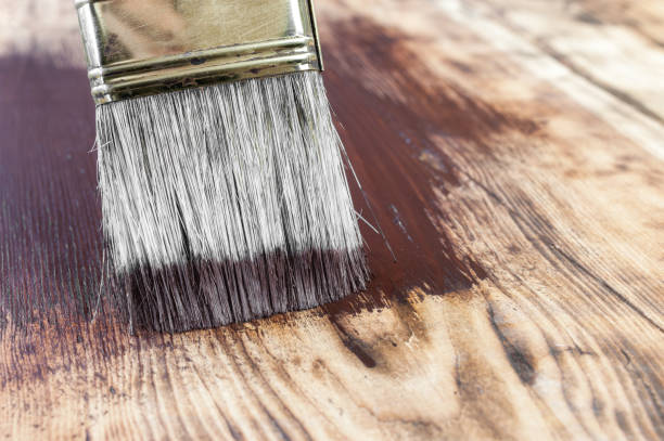 istock Paint brush on wooden surface 1259107927