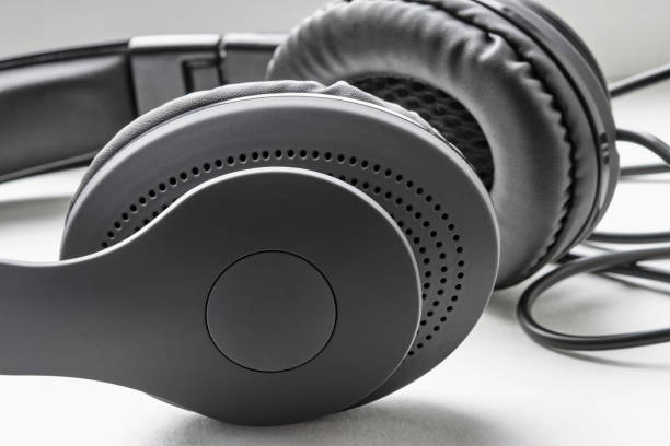istock Black headphones lie on white background. Closeup 1259110510