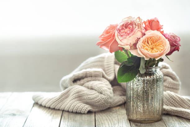 istock Cozy arrangement with roses on a wooden table 1259112493
