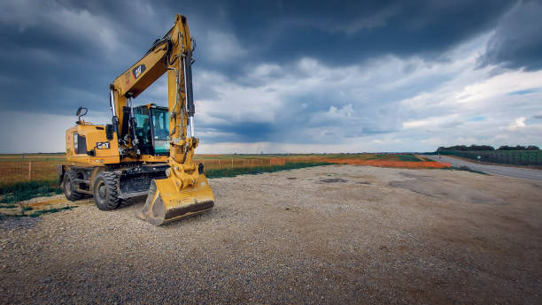 Belgrade, SRB, Serbia - July 26, 2020: Yellow CAT industrial excavator parked at the construction site in Belgrade, Serbia. The photo was made on July 26, 2020 afternoon. The photo contains no people, only CAT excavator.
