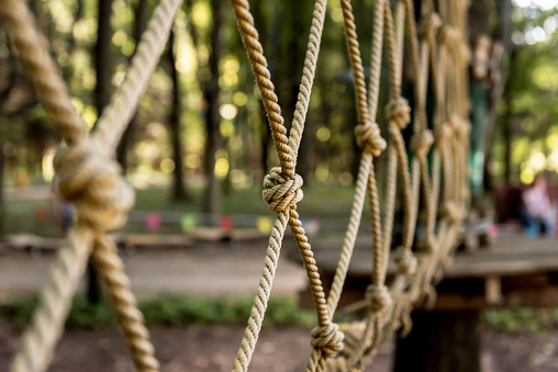 Detail of rope park in a forest. Adventure summer park. Nature background