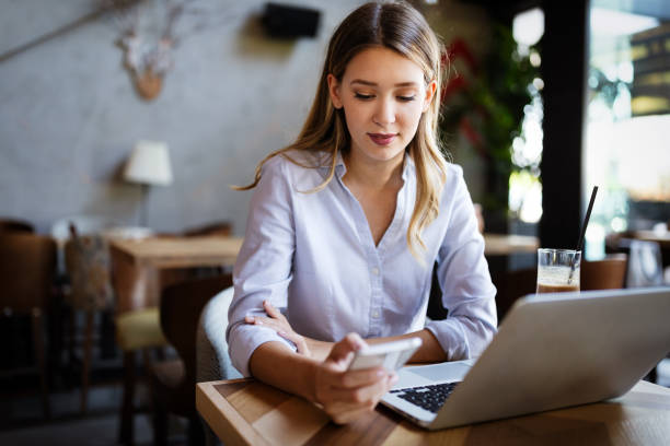 istock Beautiful business woman using notebook in cafe 1259123476