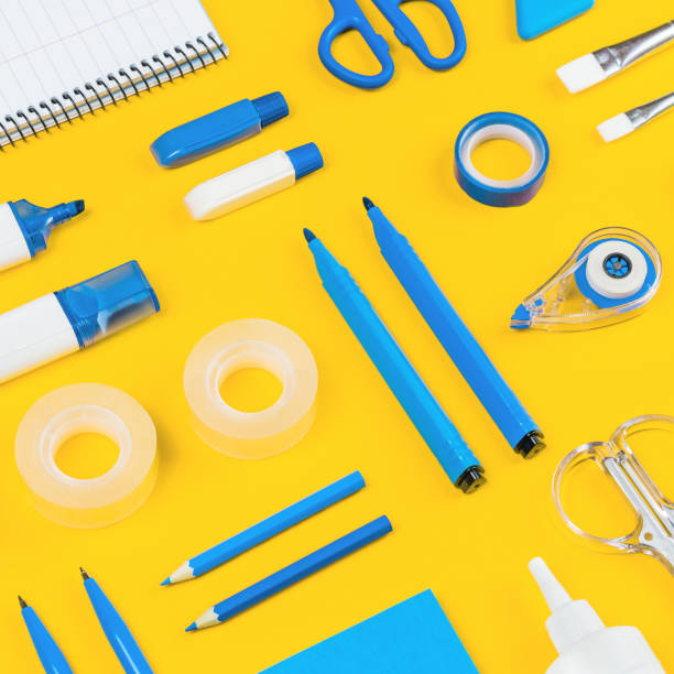 istock Assorted office and school white and blue stationery on yellow 1259136310
