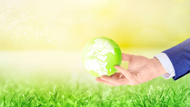 istock Businessman holding green planet Earth globe 1259136713