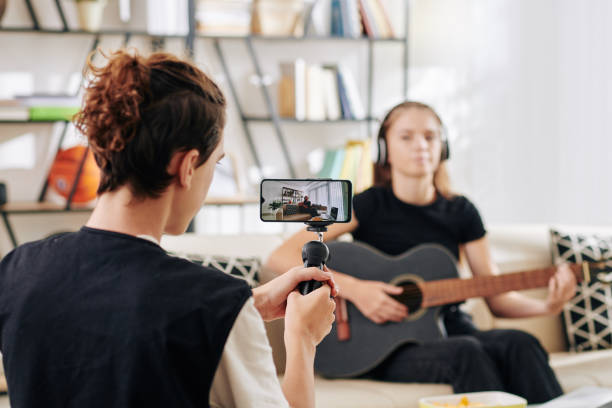 istock Teenager shooting singing friend 1259139004